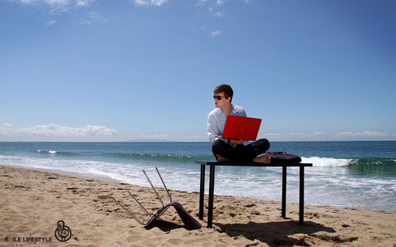 Colin Wright on a Beach with his Laptop